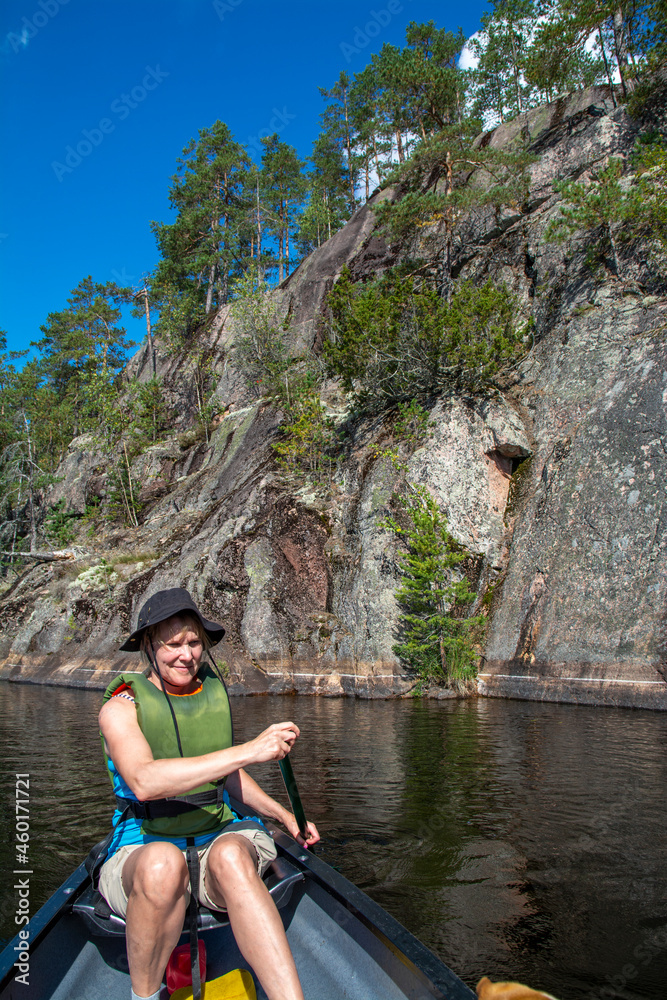 Woman canoeing on lake in Finland