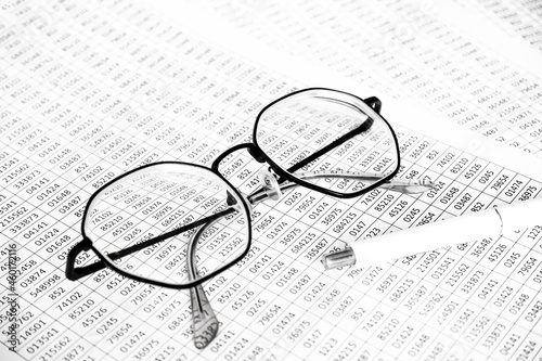 finance business calculation with glasses  tables with numbers and pen. business concept. financial literacy. accounting of income and expenses