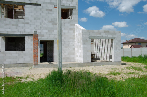 Building site of a house under construction made from white foam concrete blocks. Building new frame of home. © Алексей Ковалев