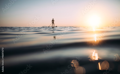 Fototapeta Naklejka Na Ścianę i Meble -  Low angle view of man paddling SUP board