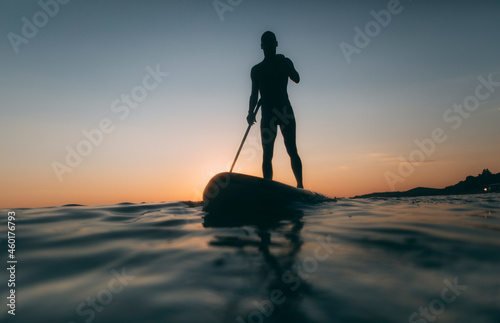 Low angle view of man silhouette paddling SUP board