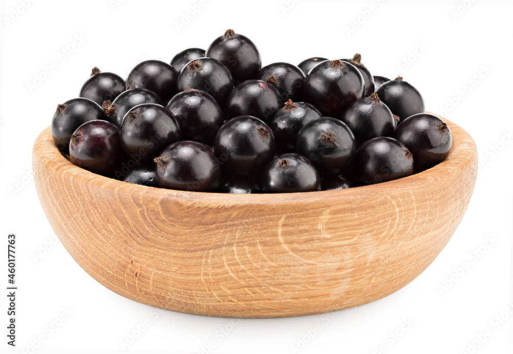 black currant in wooden bowl isolated on white background. macro. clipping path black currant in wooden bowl isolated on white background. macro. clipping path
