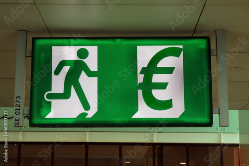 Sign with man figure running after euro symbol photo