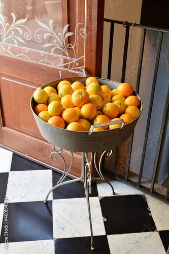 Orange fruit in metla bucket photo