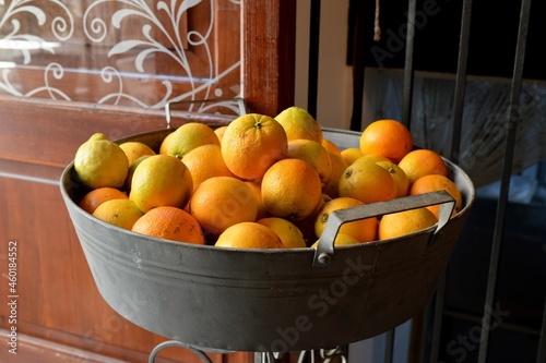 Orange fruit in metla bucket photo