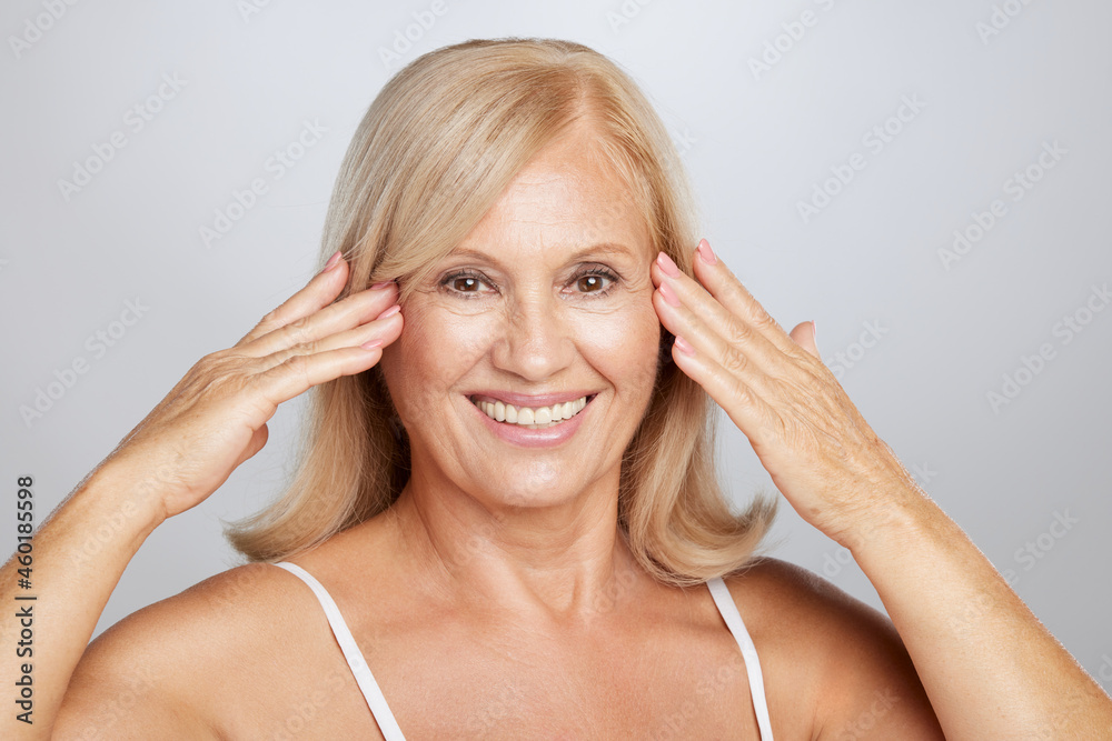 Close up of a beautiful senior lady touching her soft wrinkled skin. Beauty photography Close up of a beautiful senior lady touching her soft wrinkled skin. Beauty photography