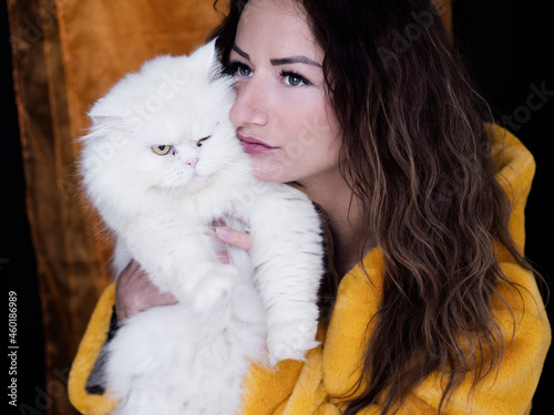 woman holding a white fluffy cat