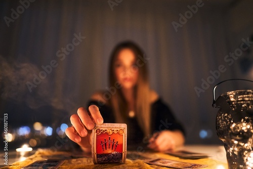 Woman reading tarot cards in spiritual room
