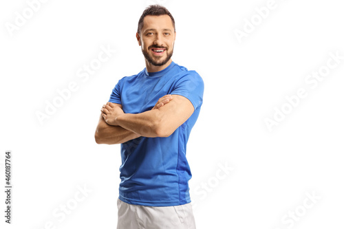 Tableau sur toile Portrait of a young male athlete in a blue jersey posing with crossed hands