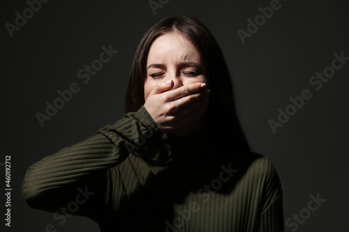 Stressed young woman coveri...