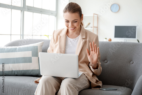 Young woman with laptop vid...