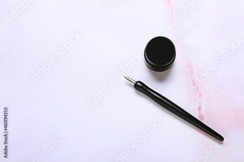 Nib pen with ink on white b...