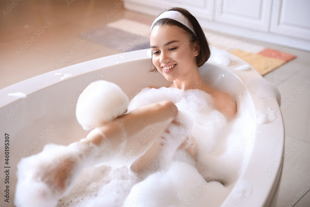 Young woman taking bath with foam at home Young woman taking bath with foam at home