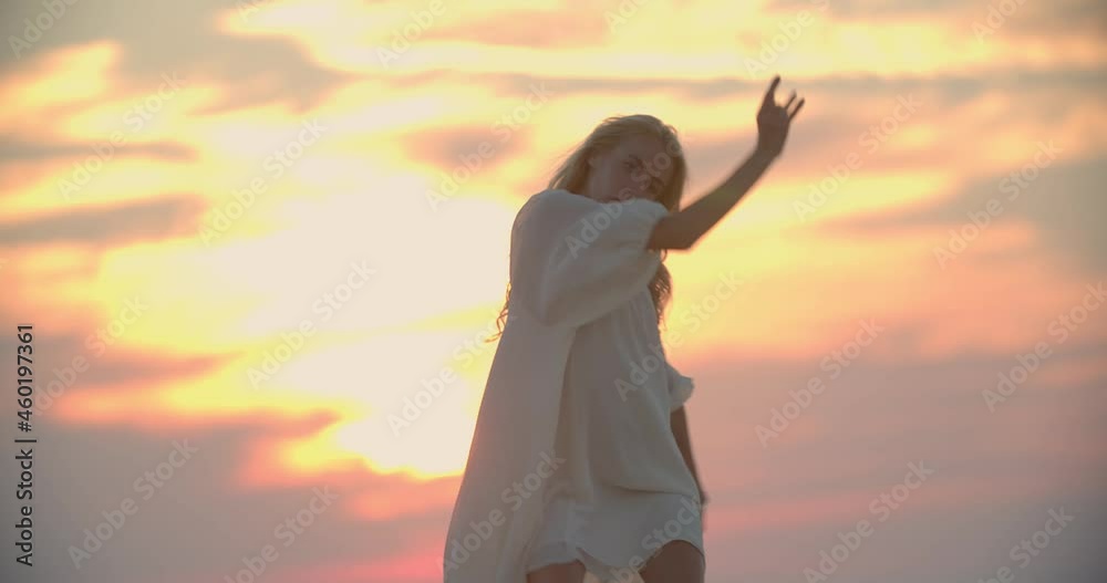 Happy young woman is dancing on the pier of a lake during amazing sunset, 4k Happy young woman is dancing on the pier of a lake during amazing sunset, 4k