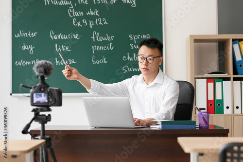 Asian teacher conducting En...