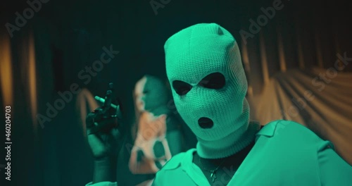 A sexy criminal woman wearing a white facemask and smoking a cigarette in a dark room shot in 4K