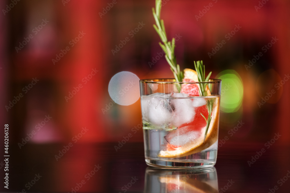 Glass of cold gin and tonic on table in bar