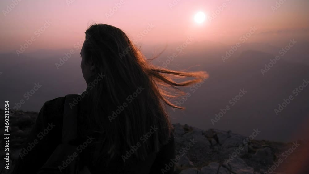 Girl is watching the Garda lake sunset in Italy - Panning Shot Girl is watching the Garda lake sunset in Italy - Panning Shot