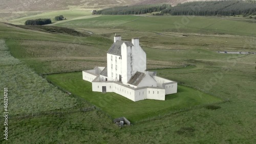 Aerial view of Corgarff Castle on an sunny day, Aberdeenshire, Scotland. Right to left rotating around the castle whilst slightly zooming in. photo