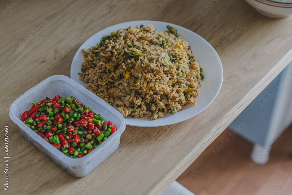Stir fried rice with fish sauce and chili on wood table for eating. Stir fried rice with fish sauce and chili on wood table for eating.