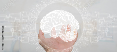 Tableau sur toile Close up of businessman holding digital image of brain in palm