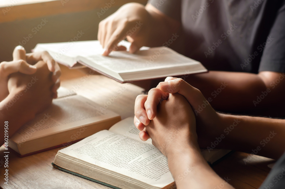 Christians join a group of cells that come together to pray for God's blessings. with the Bible and his friends sitting and reading the Bible Share the gospel with copy space Christians join a group of cells that come together to pray for God's blessings. with the Bible and his friends sitting and reading the Bible Share the gospel with copy space