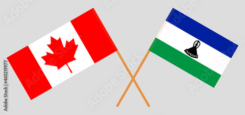 Crossed flags of the Kingdom of Lesotho and Canada. Official colors. Correct proportion