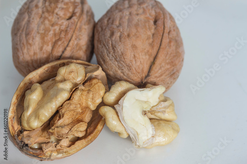 fruits of a ripe walnut on a gray-white background close-up