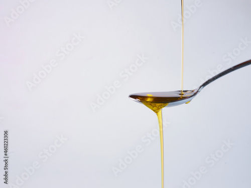 Pouring fresh olive oil into spoon