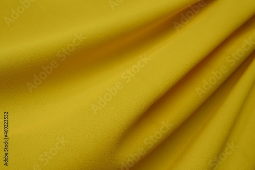 Draped bright yellow polyester fabric background