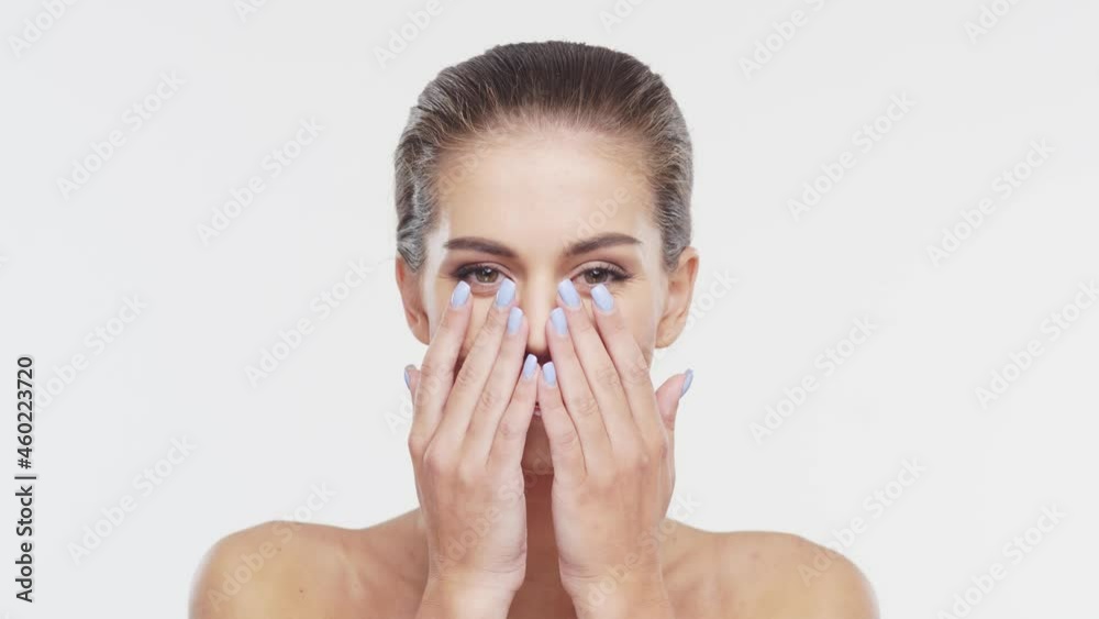 Beauty portrait of young, attractive and healthy woman. Brunette girl is laughing over white background. Natural female face.