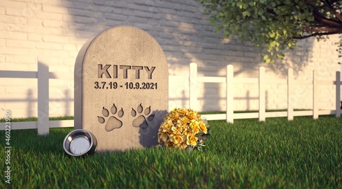 Pet grave in the garden. Gravestone with the cat's name. photo