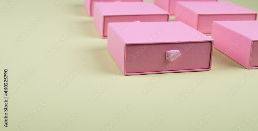 Lot of square pink carton boxes on green background Lot of square pink carton boxes on green background