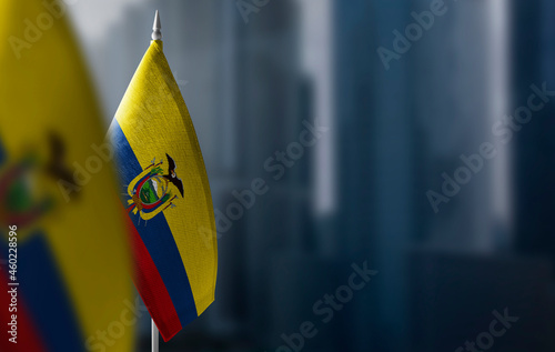 Small flags of Ecuador on a blurry background of the city