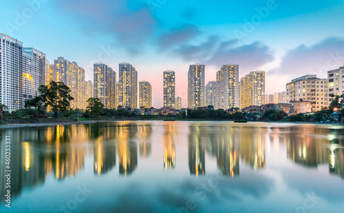 Building reflection on water during blue hour. Times city Hanoi. Wallpaper.  High quality