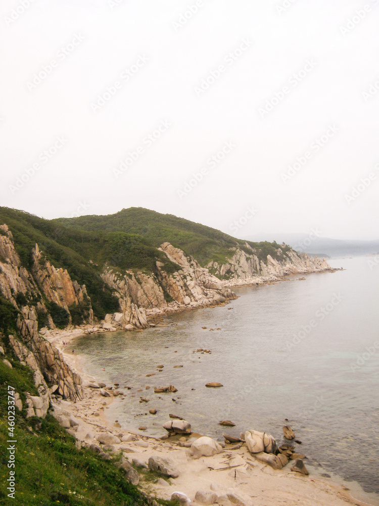 View of the sea shore with mountains and beaches, the water with a wave. Seascape, Japan Sea, Far East, Spokoynaya and Ezhovaya bay