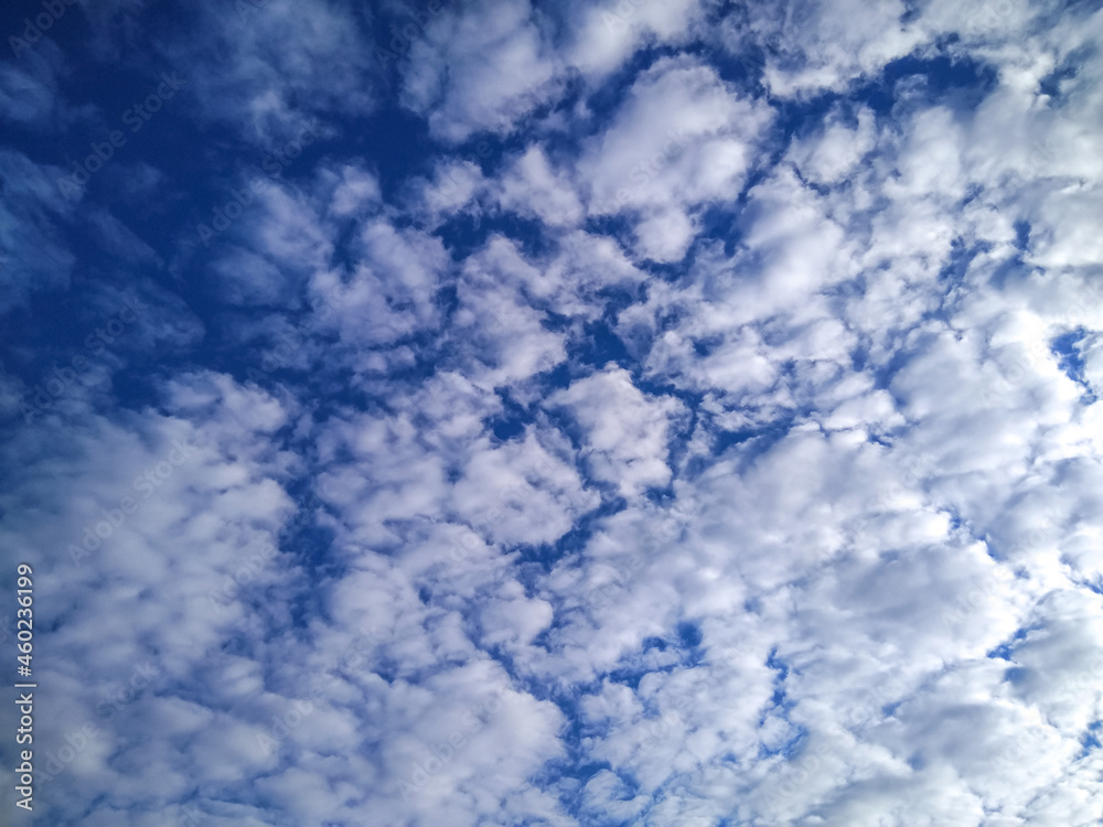 Sunny weather. Blue sky with beautiful cumulus clouds in the rays. Background for design work Sunny weather. Blue sky with beautiful cumulus clouds in the rays. Background for design work