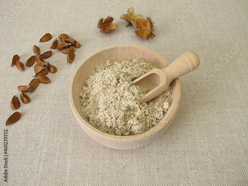 Gluten-free beechnut flour, ground beechnuts in a wooden bowl photo