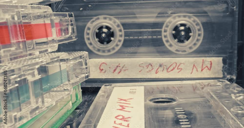 Spinning cassette in player. Vintage cassette tapes and headphones