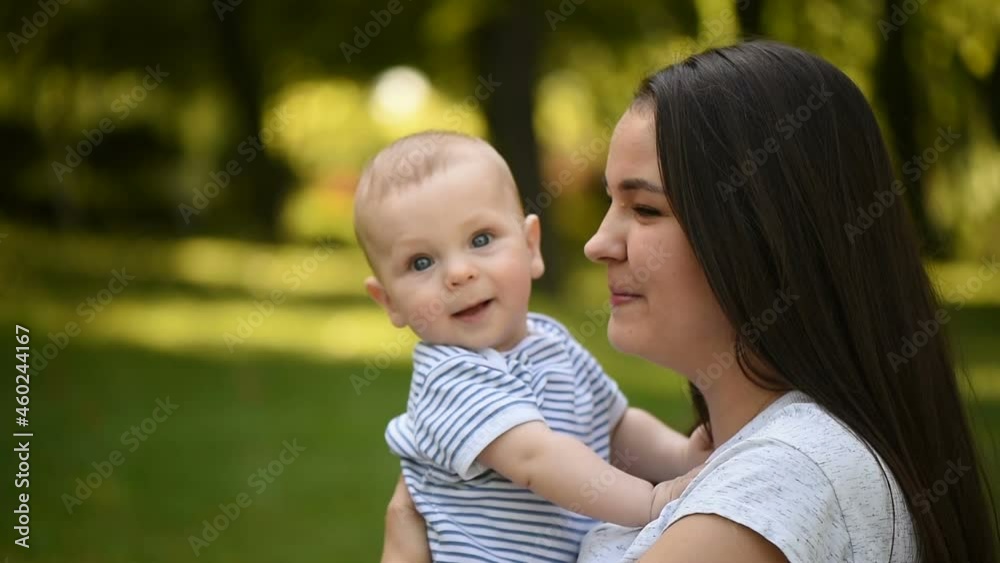 Happy harmonious family in the open air. Portrait of a mother and a small child in her arms. Happy harmonious family in the open air. Portrait of a mother and a small child in her arms.