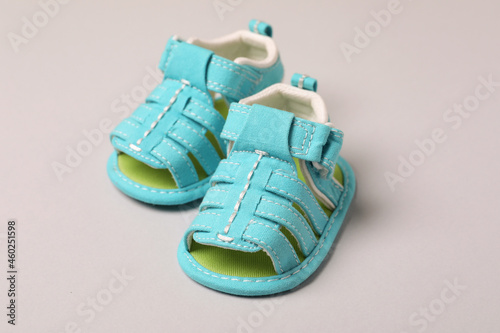 Mint baby sandals on light gray background
