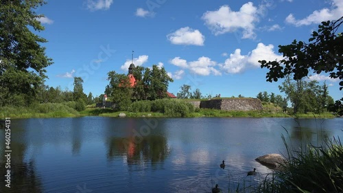 Ducks swimming on the calm water of a lake adjacent to the Museum fortress korela, Russia. photo