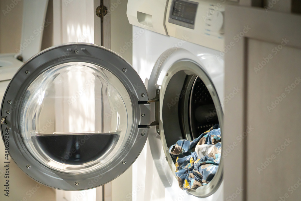 Washing machine with open door at home. Washing machine with open door at home.