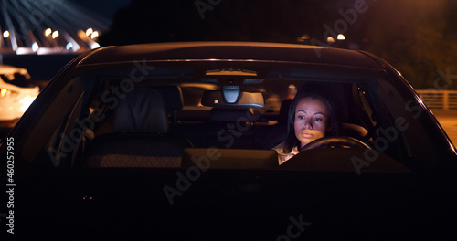 Mixed-race businesswoman sitting in car at parking lot