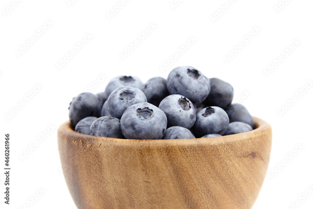 Blueberry in wooden bowl isolated on white background Blueberry in wooden bowl isolated on white background