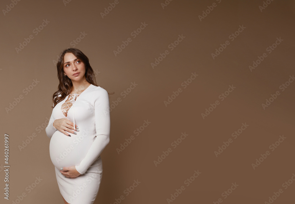 pregnant girl in studio on paper background pregnant girl in studio on paper background