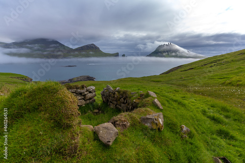 Mystical foggy lansdcapes along the coast of Vagar Island, Faroe Islands photo