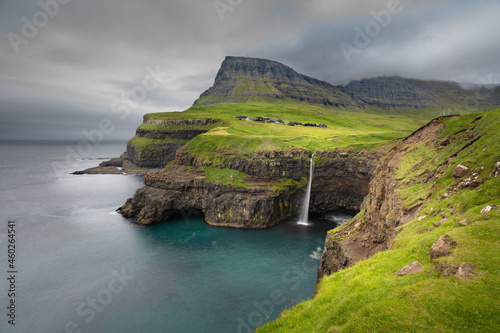 Breathtaking view of the iconic Múlafossur waterfall on Vagar Island, Faroe Islands.