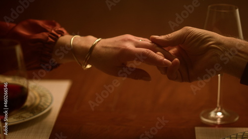 Senior love couple hands holding at home closeup. Old people arms separating