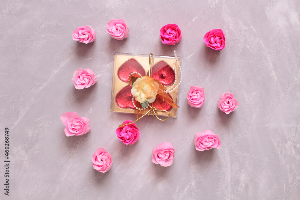 Soap in form of rose buds on stone background